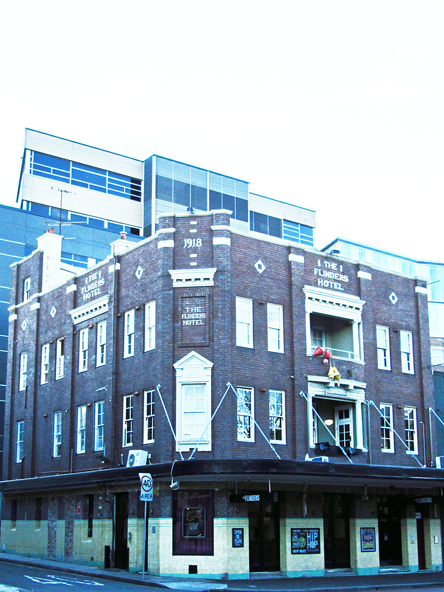 a large brick building is on a corner