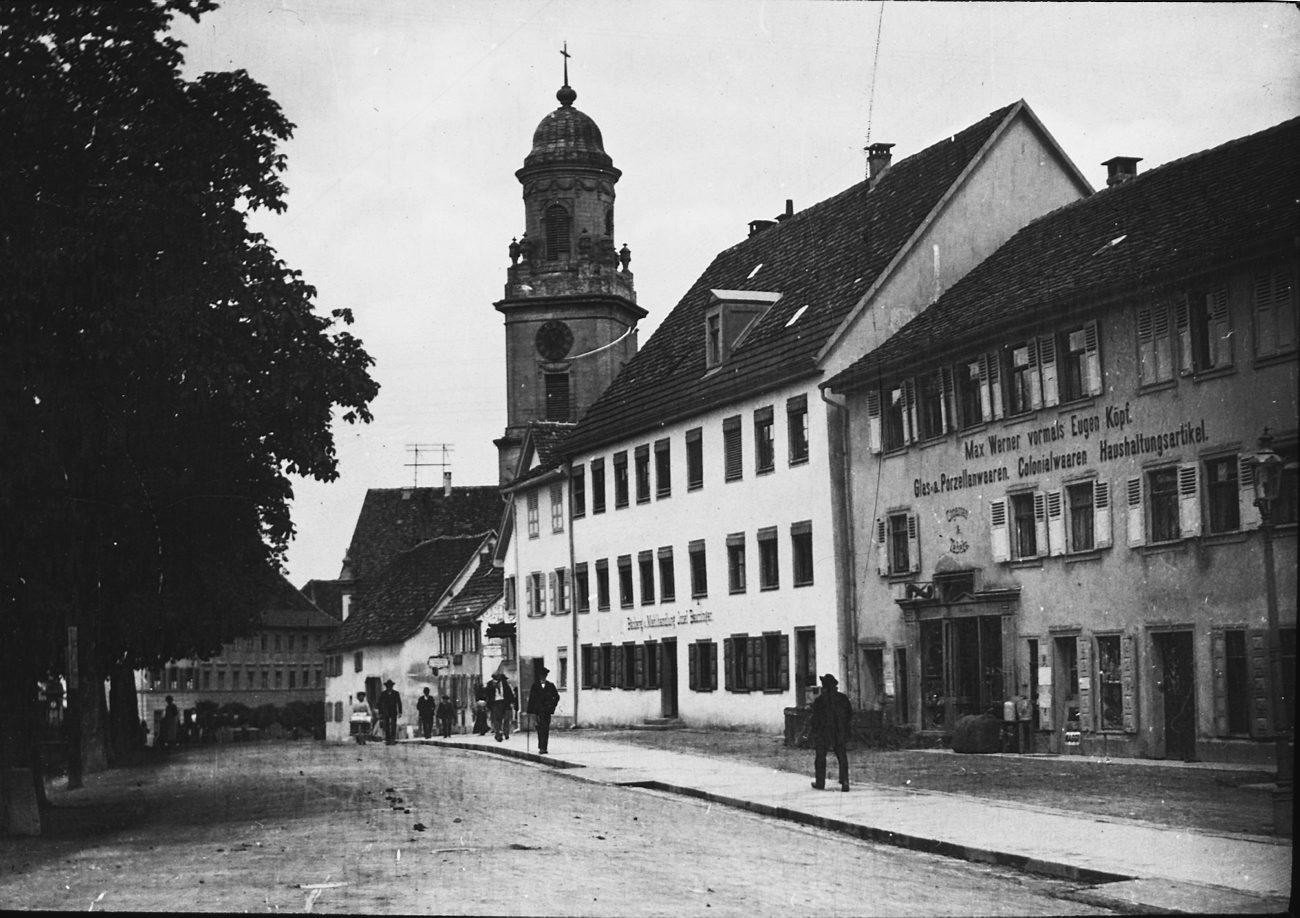 old black and white po with people in front of buildings