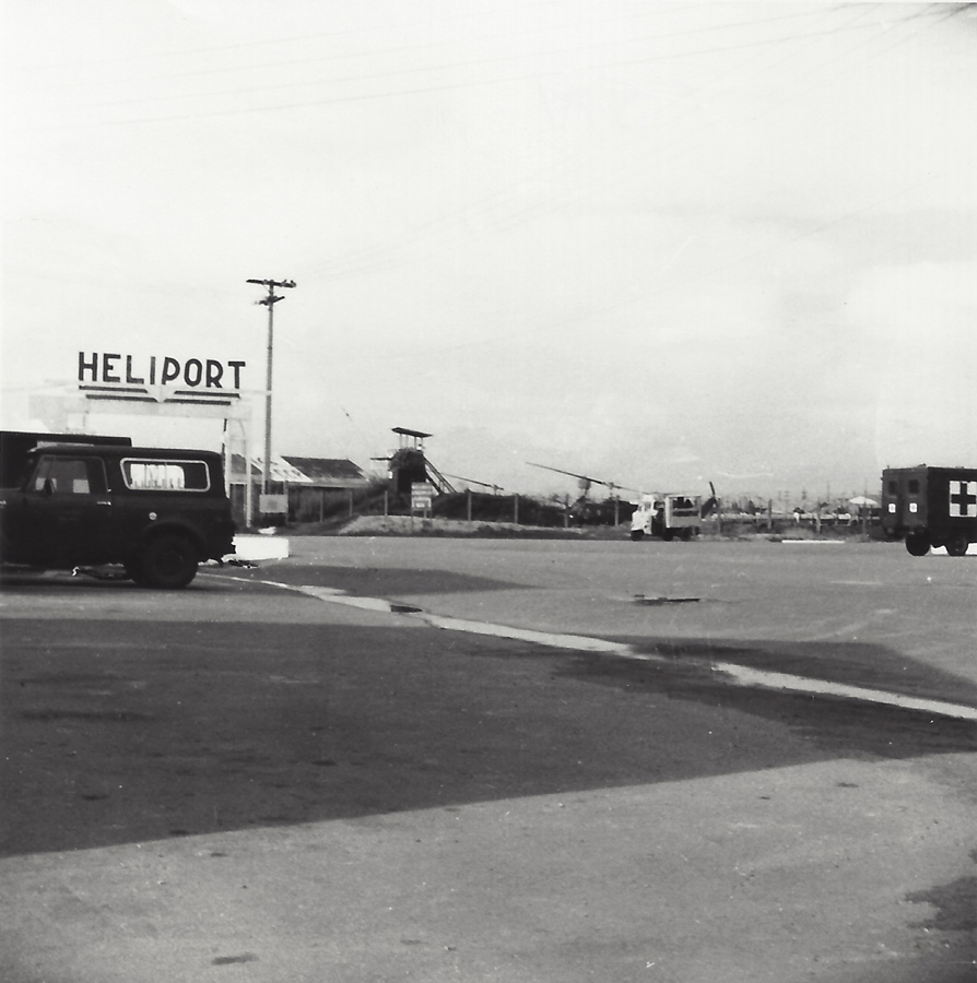 black and white pograph of trucks near stores