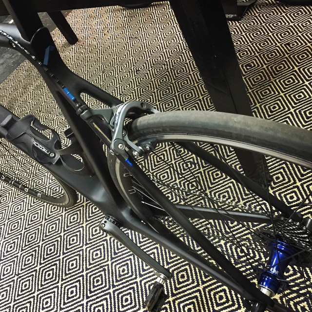 a bike parked on a carpet under a table