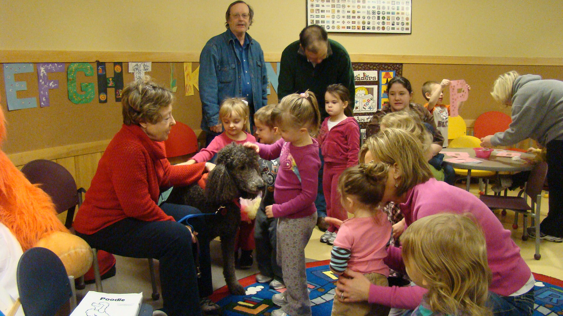 many children are in a classroom together with teachers