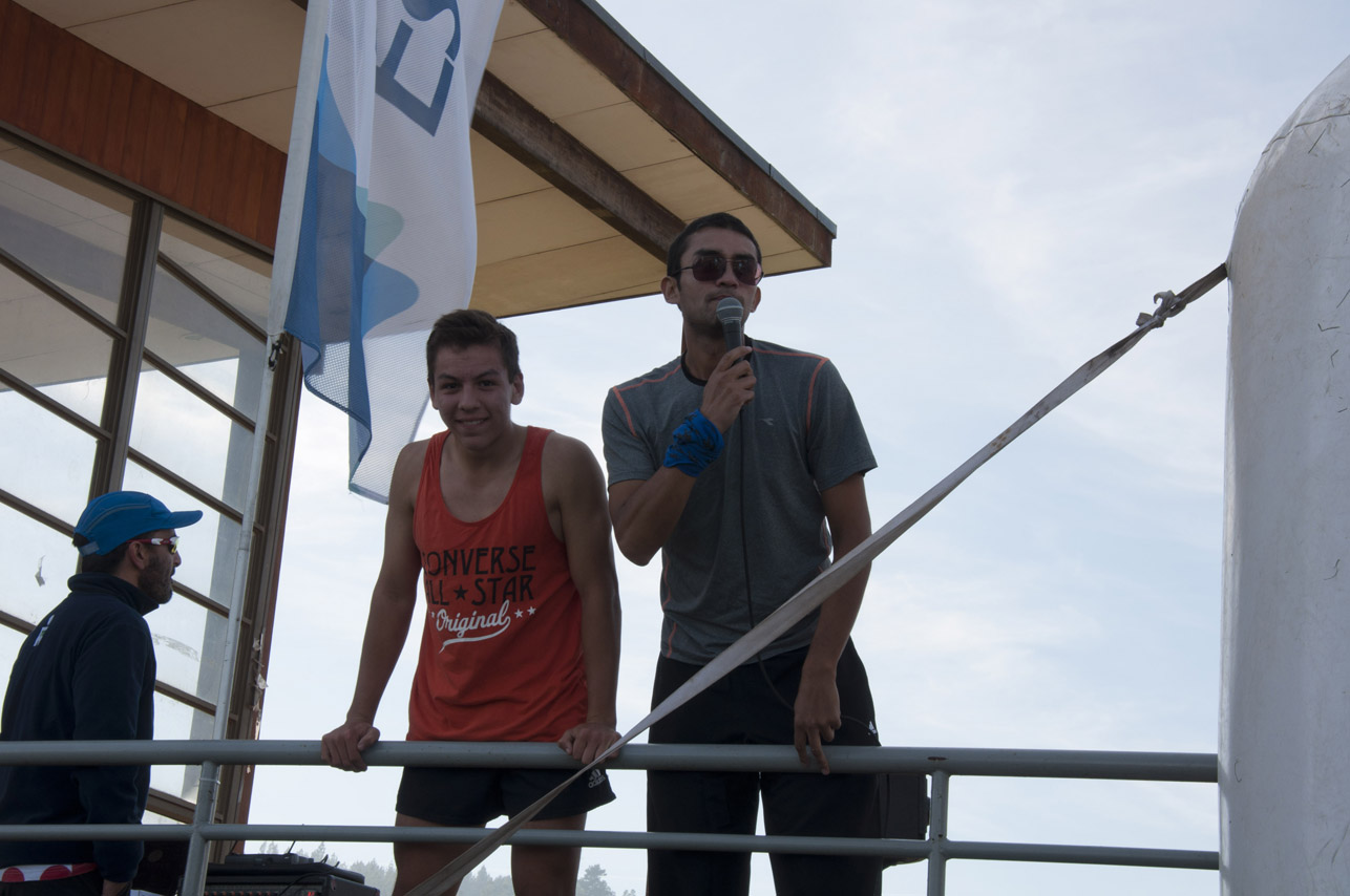 two men are on a boat posing for a picture