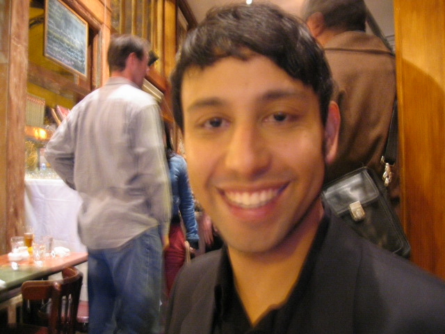 a man is posing for the camera inside a restaurant
