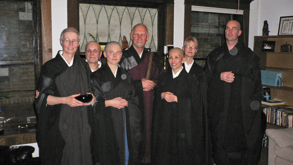 group of older people with robes on posing for picture