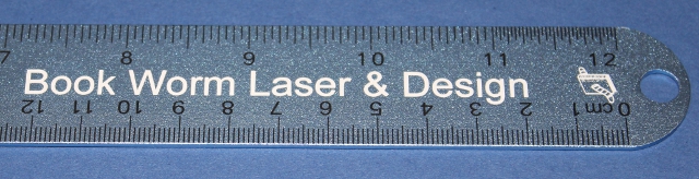 a ruler with a sticker that reads book worm laser & design
