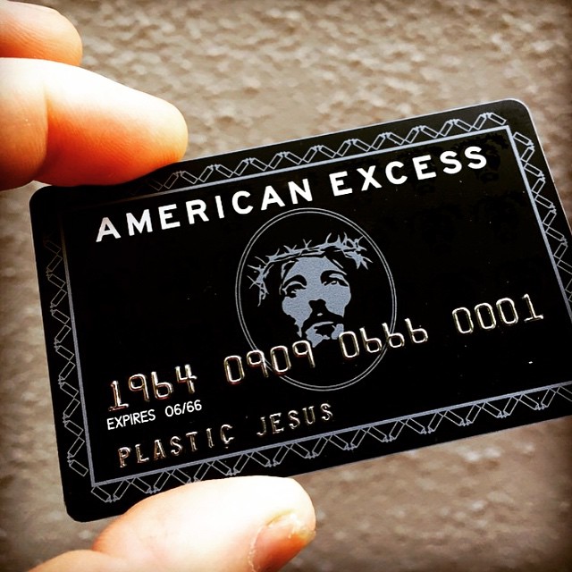 the american express card is black and white with a logo on it