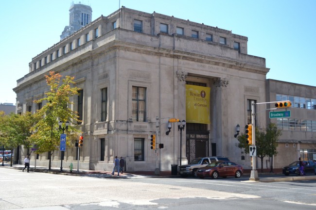 large brick building with three stories on street corner