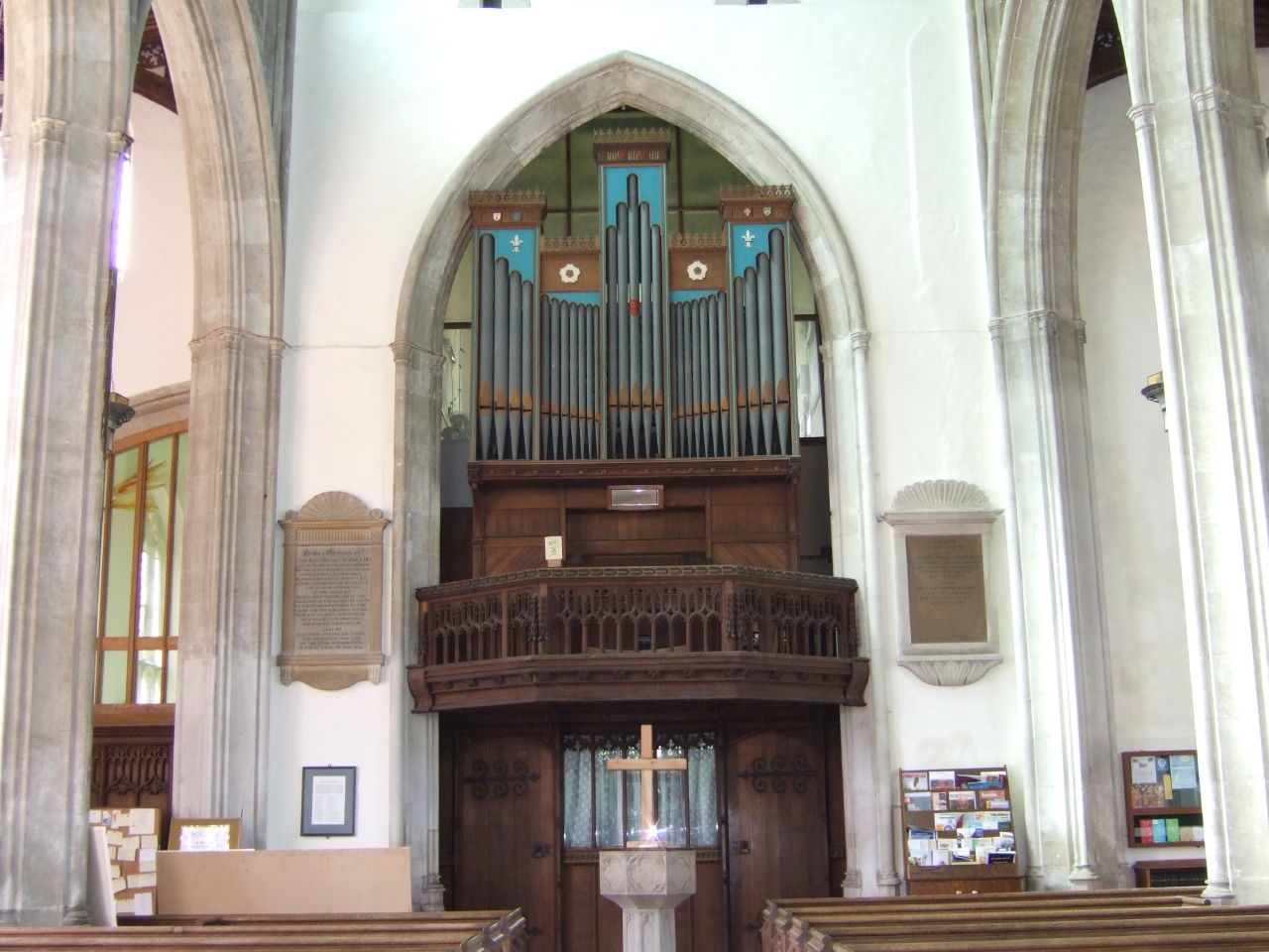 a room with a big organ and several altars