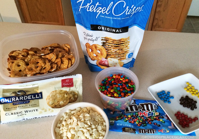several snacks including cereal, milk, and pretzels in containers