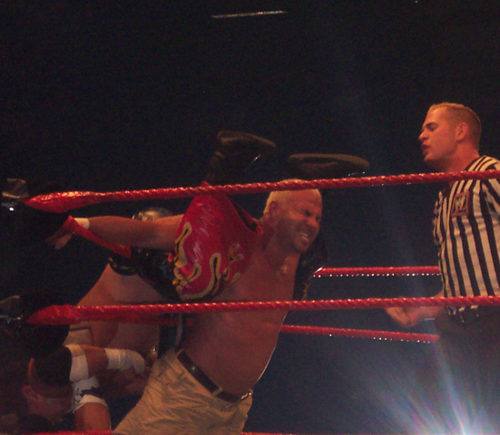 a man in a ring with an official referee