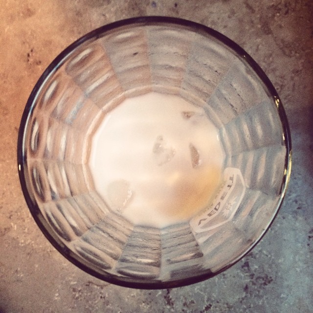 a glass bowl containing milk on the ground