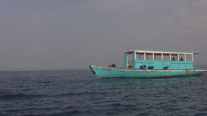 a large boat floating in the middle of a large body of water