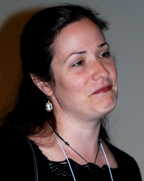a woman wearing ear wires, looking to the side