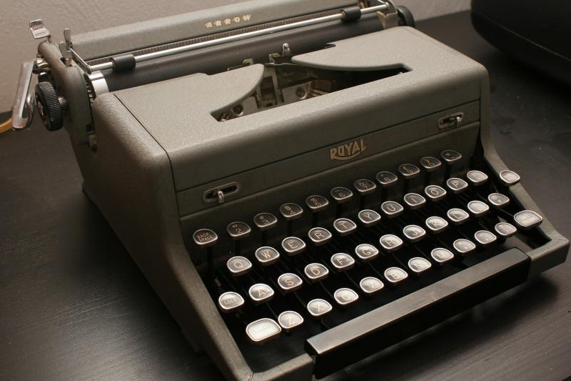 an old - fashioned typewriter sitting on a table