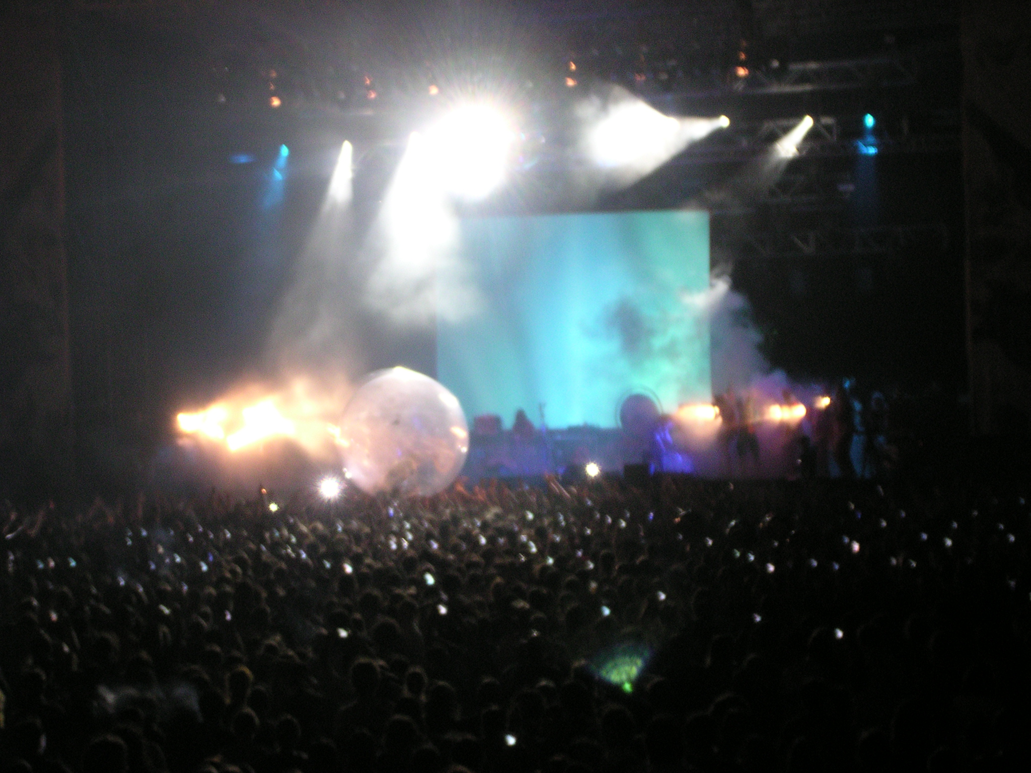 concert with stage lights and fans at night