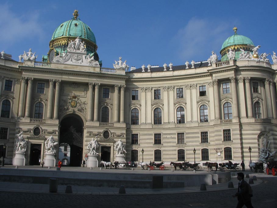 a man walks in front of an ornate building