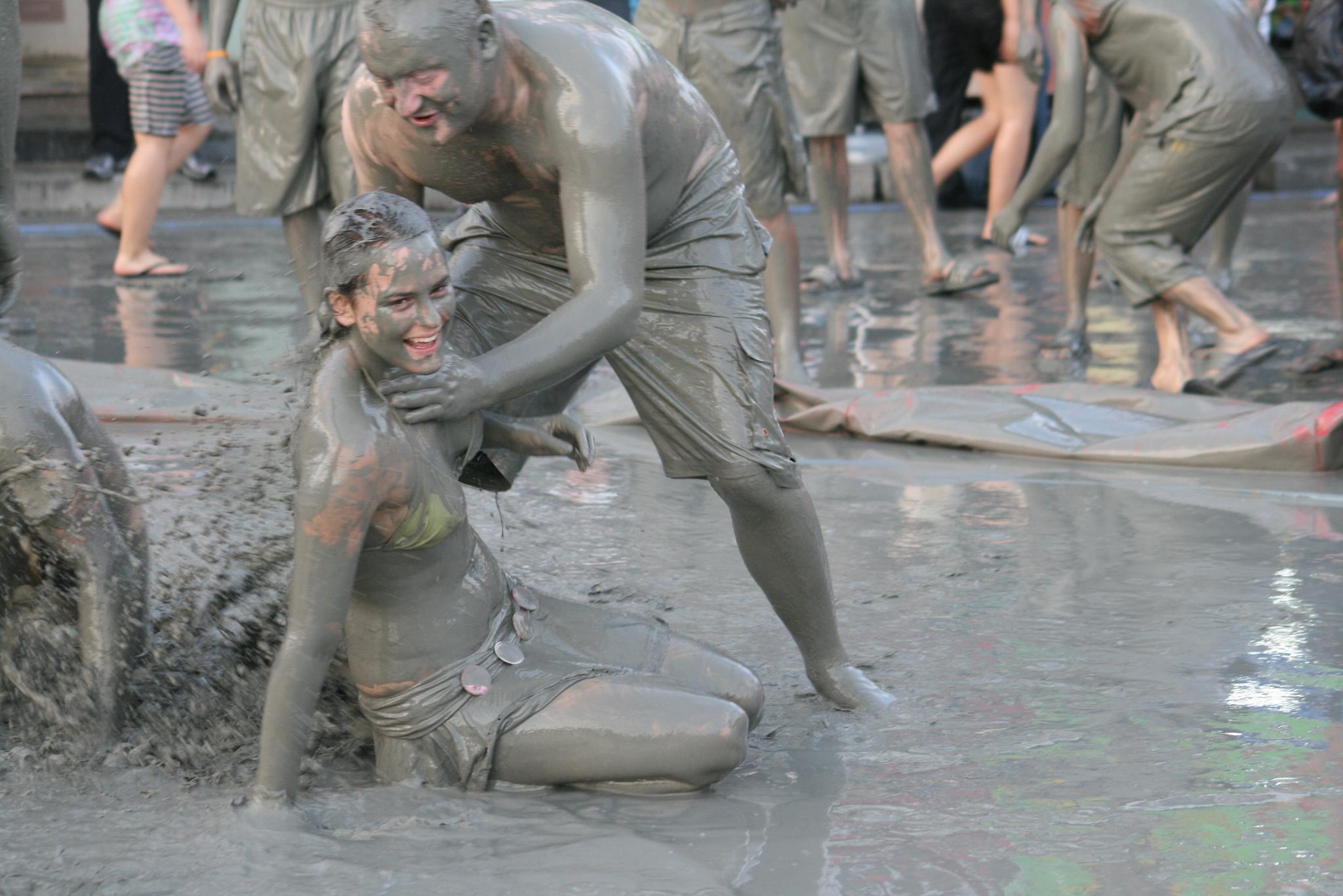 some people playing with mud on a street