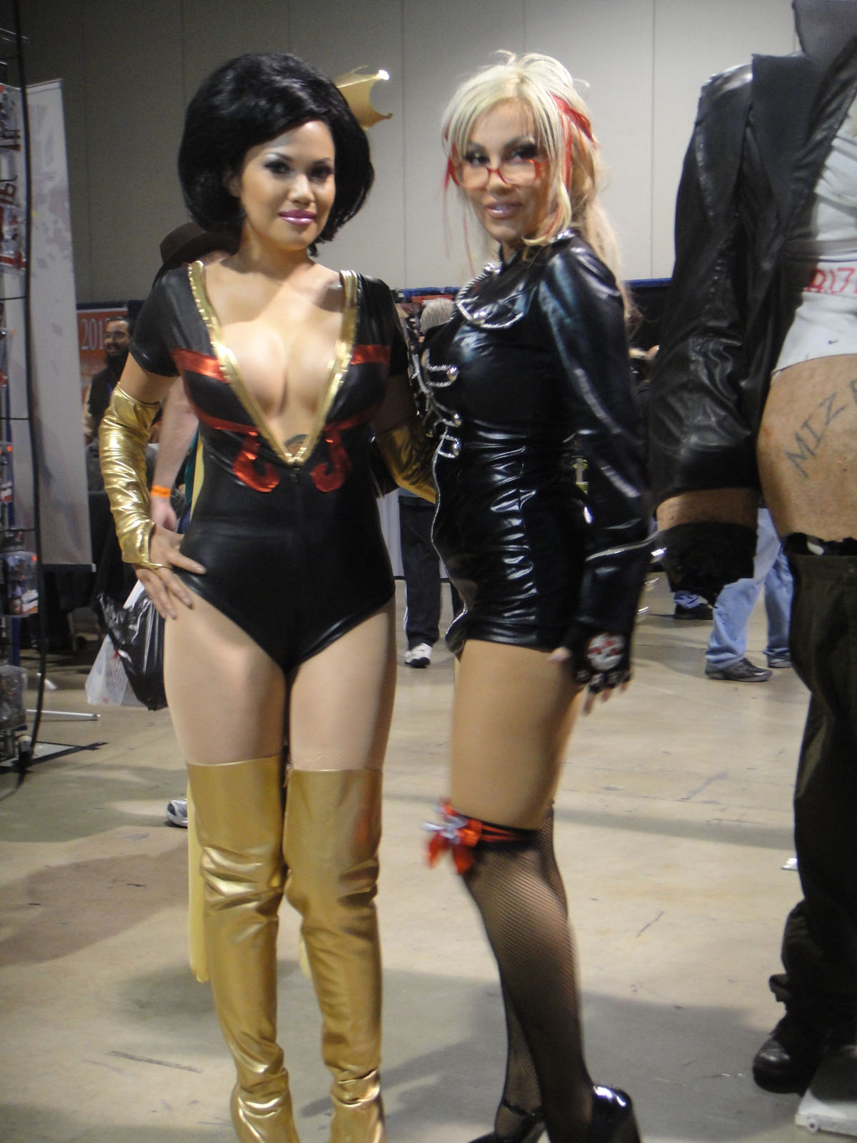 two women wearing costumes pose for a picture