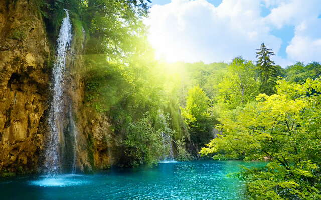 the image is of a waterfall with blue water