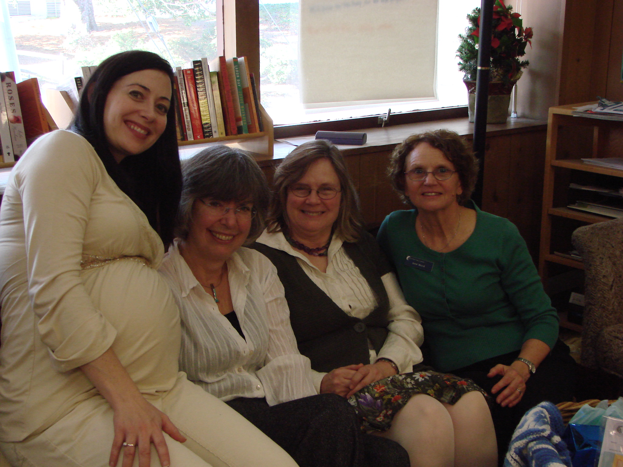 two women sitting together with their arms around each other