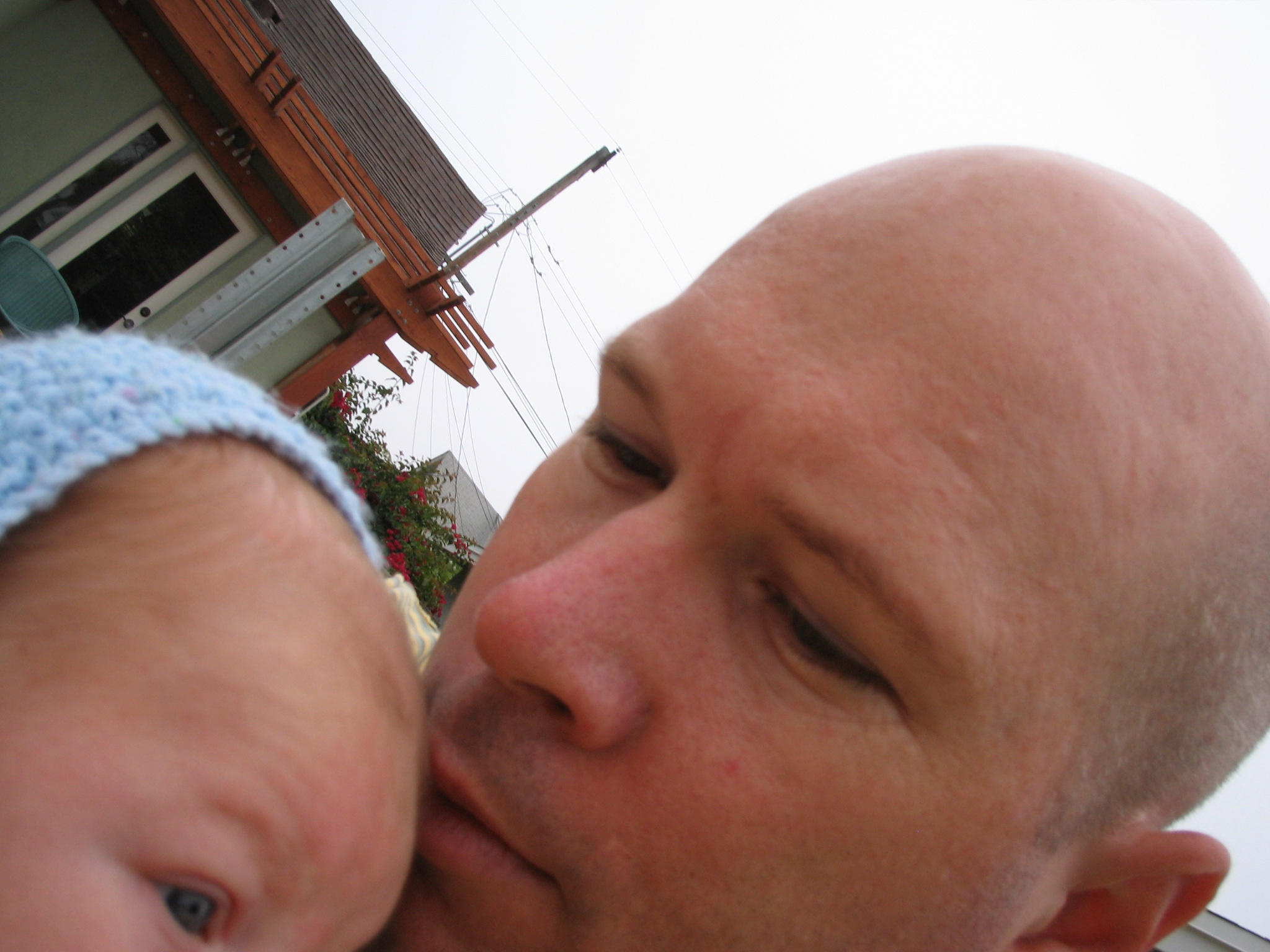 a young man is kissing the forehead of his baby