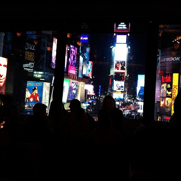 a nighttime scene of many people standing in the city