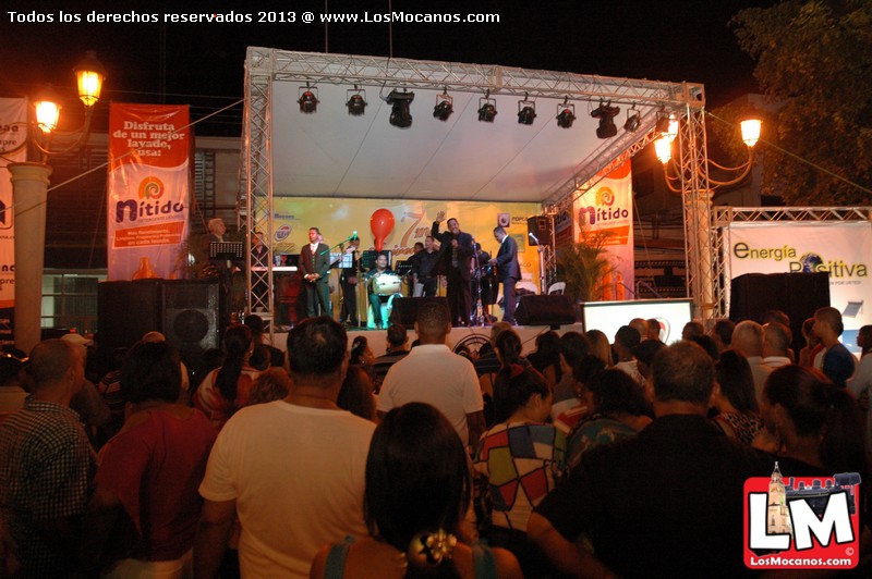 an image of a band on stage with people looking on