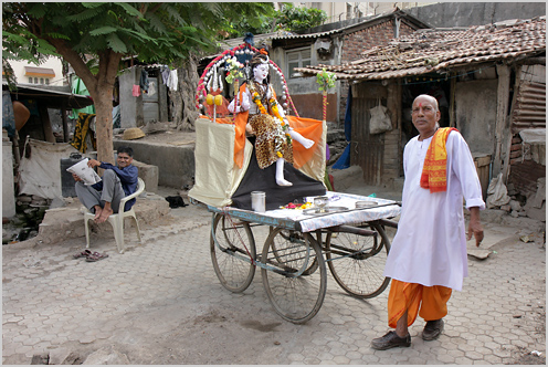 a man walks by an indian style shrine