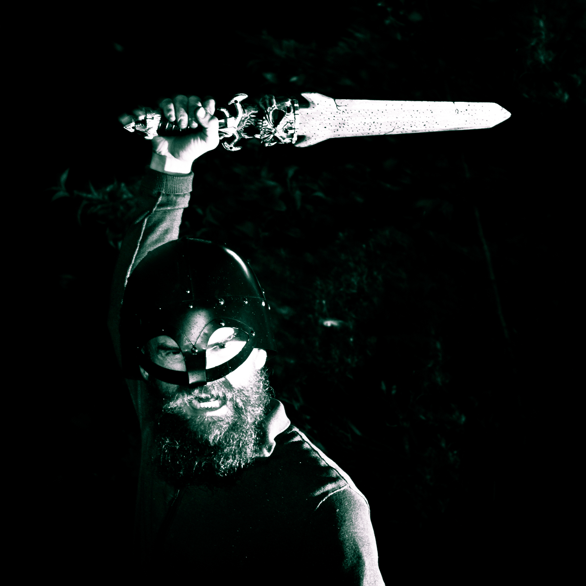 black and white pograph of a man holding a snowboard