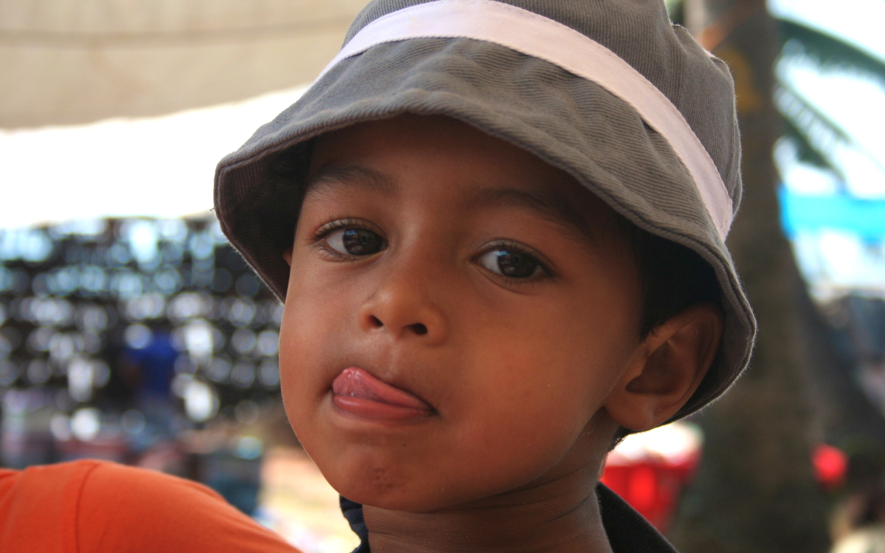 a child looking into the distance with his hat over