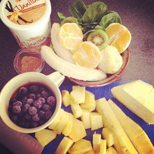 fruit and yogurt are being displayed with cups