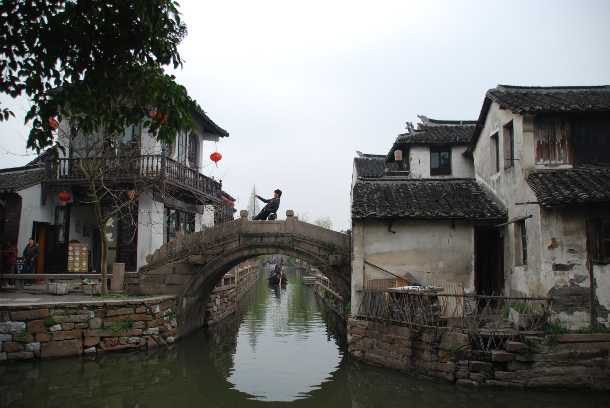 people enjoying a sunny day on an old bridge