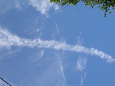 smoke trail coming out from the sky leaving contrails