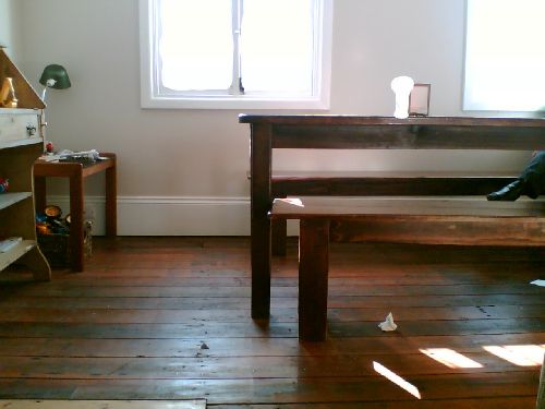 the room has wood floors and a large window