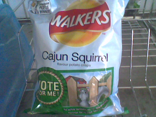 a bag of walkers'cayen squirterl sits on the trolley
