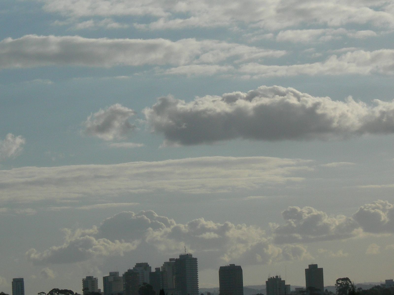 the large plane is traveling high above the clouds