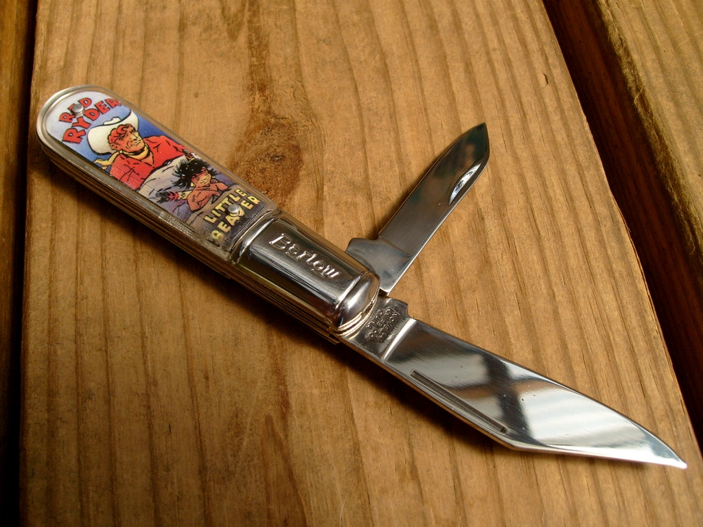 a metal and wood knife on a wooden surface