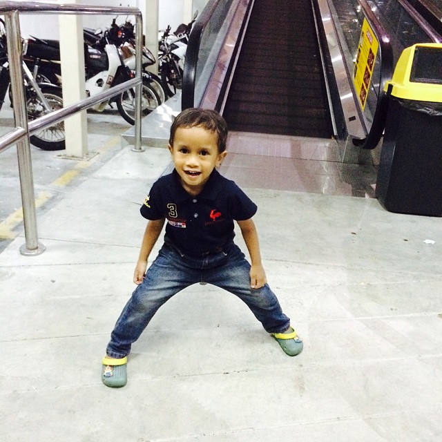 little boy on steps at a moving subway station