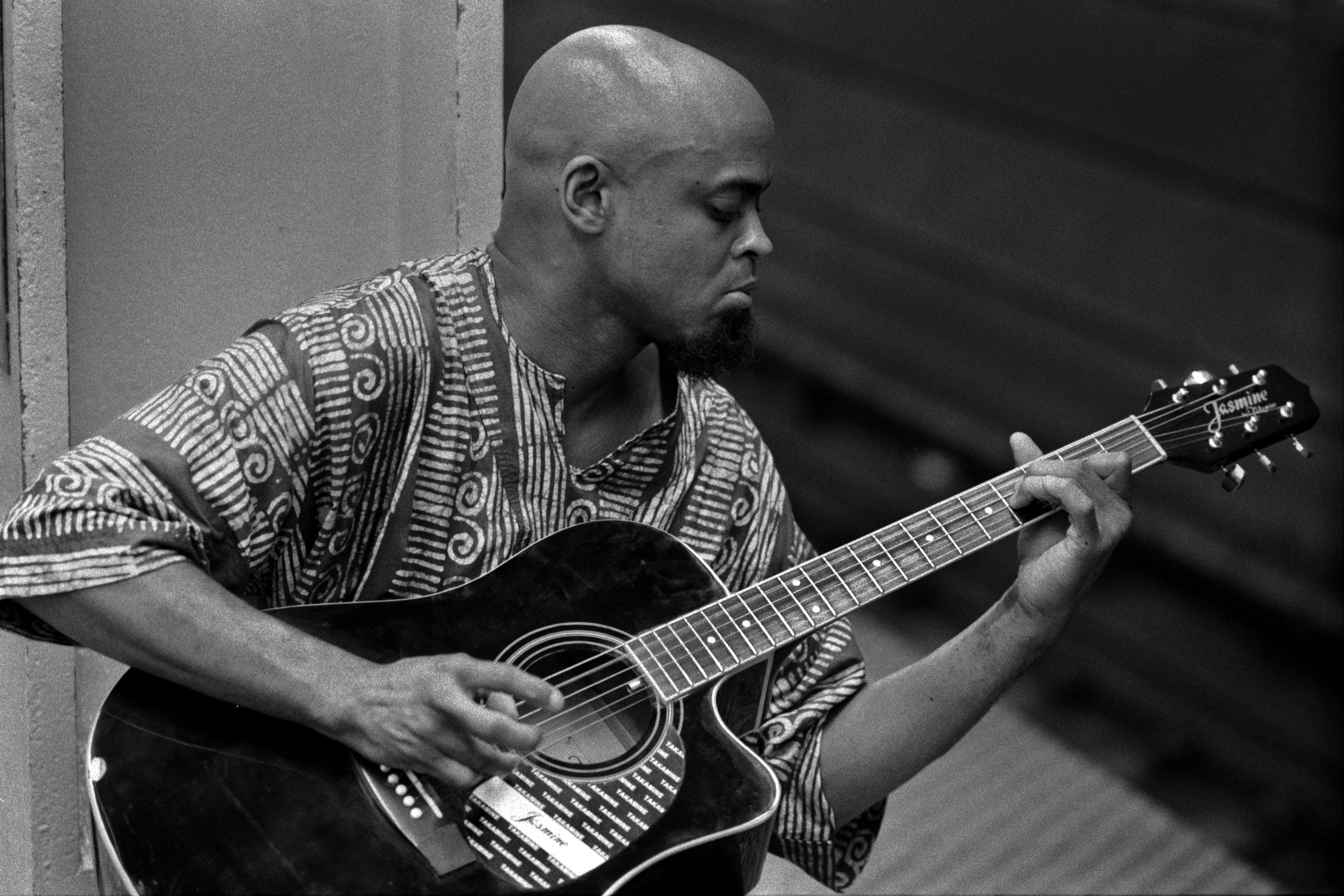 a black and white po of a man playing a guitar