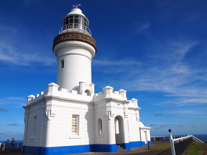 a white building with a brown top and blue side