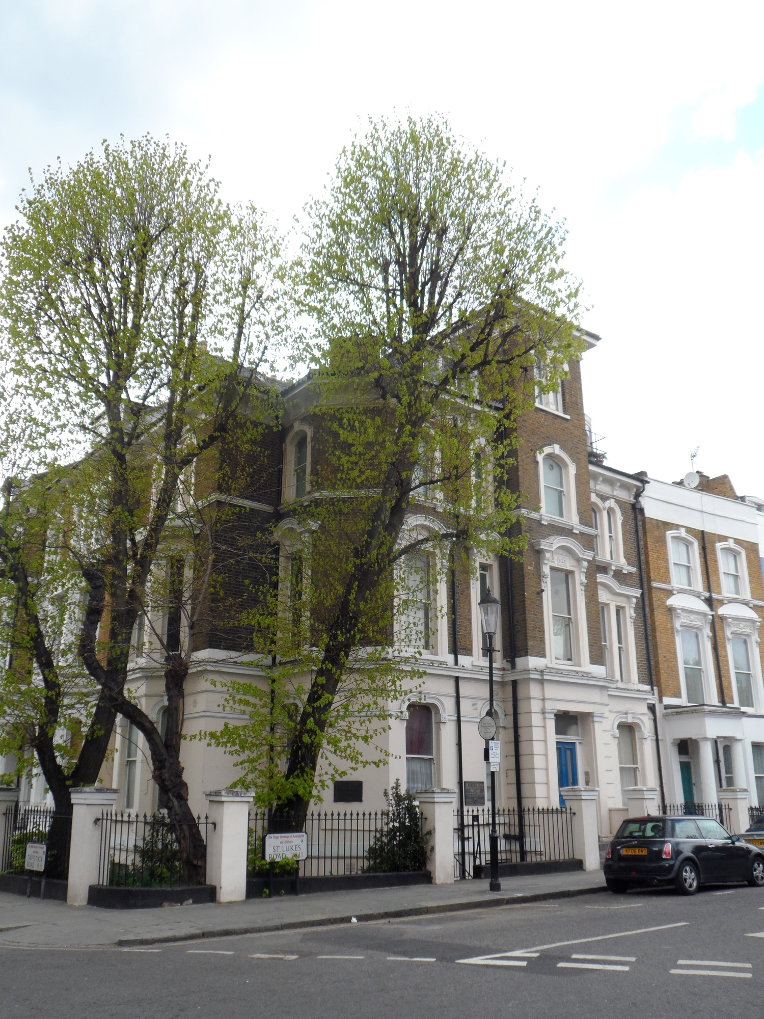 the building has many trees near it in front