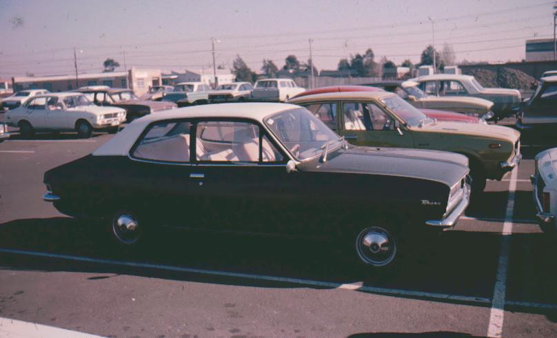 an old po shows the back side of two vehicles in a parking lot