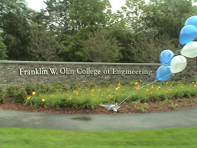 an image of a sign with balloons attached to it