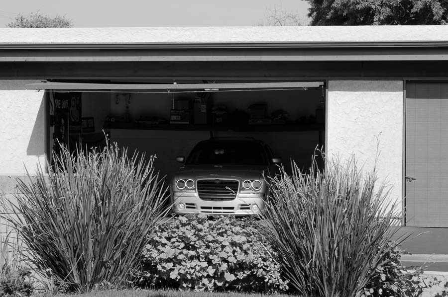 a car is parked inside a small garage