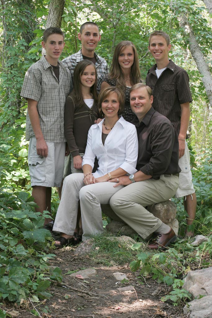 four girls standing in front of a tree wearing their casual clothes