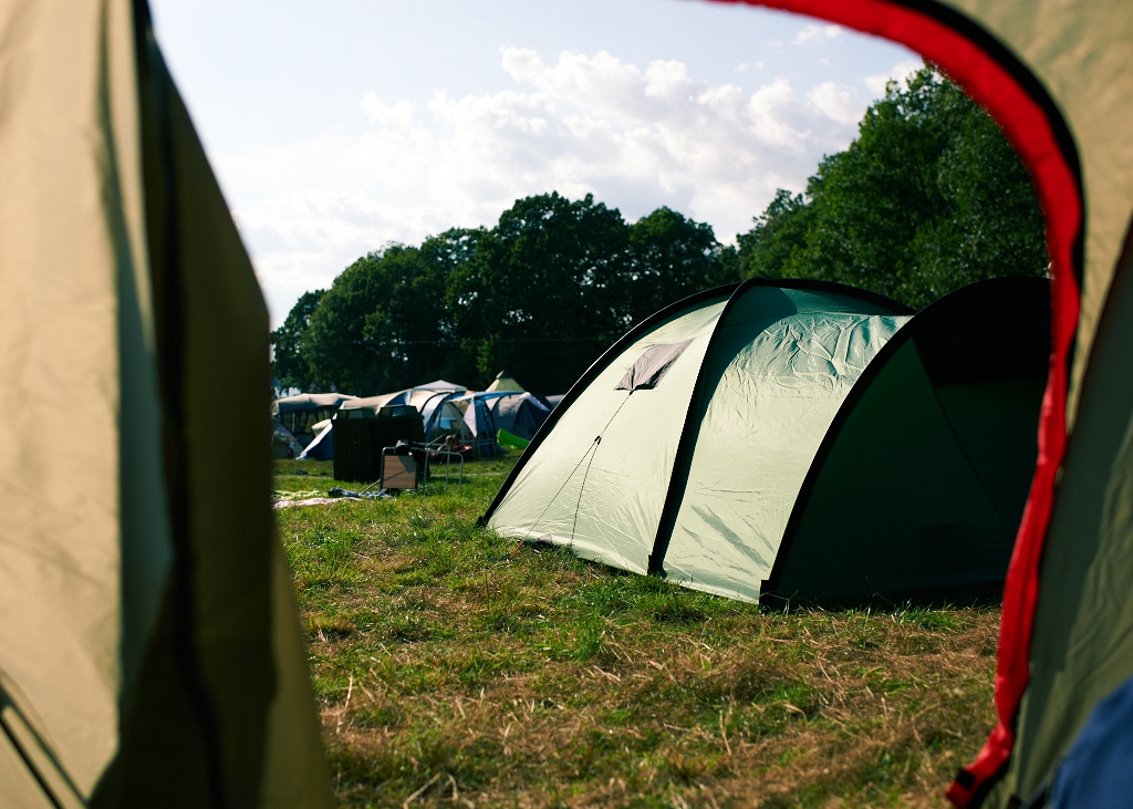 a bunch of tents on the grass outside