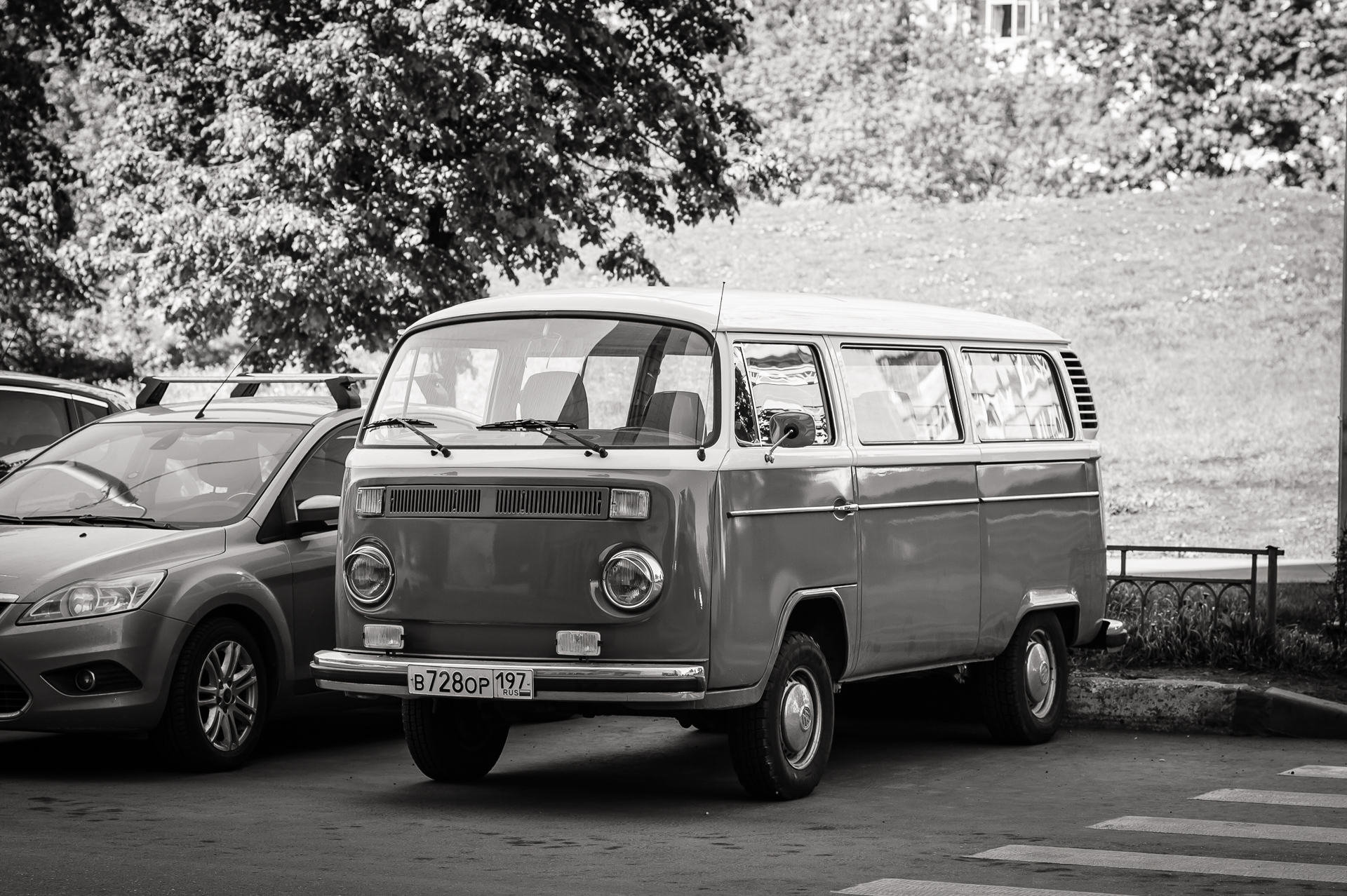 an old volkswagen van parked in the middle of a parking lot