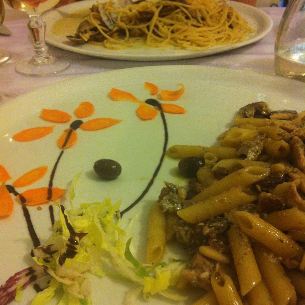 a white plate with lots of pasta and vegetables