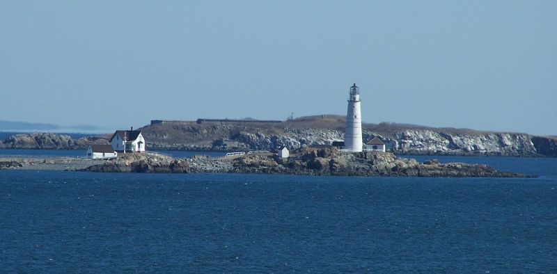 a lighthouse sits on an island in the middle of the ocean