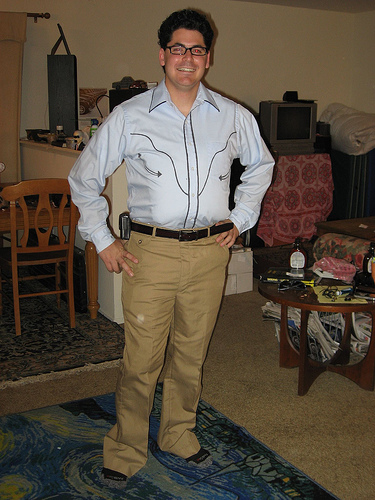 a man in the living room wearing khaki pants